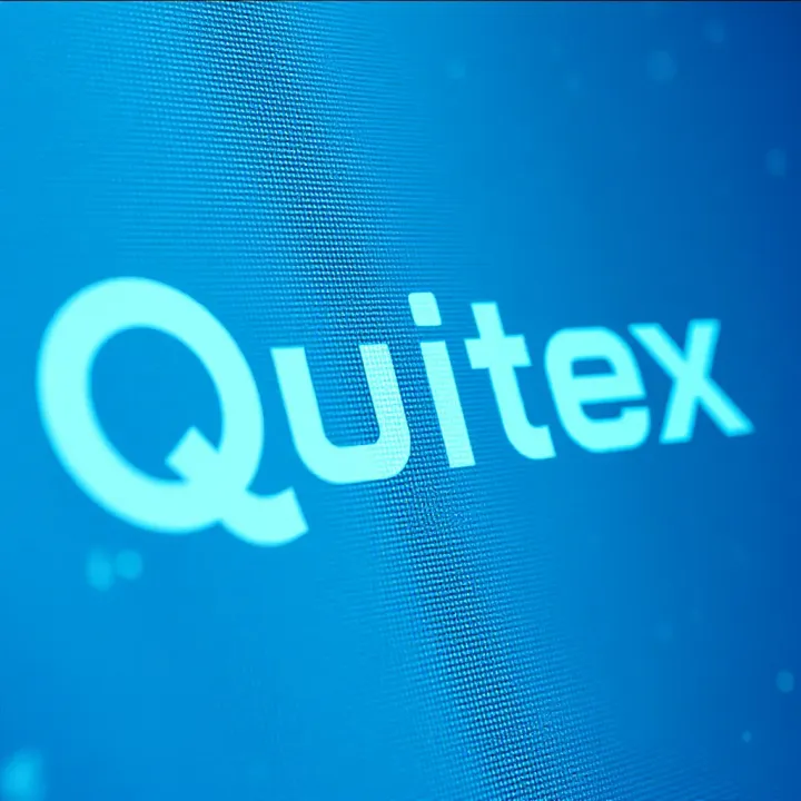 Detailed view of Quotex logo design elements including color scheme and typography